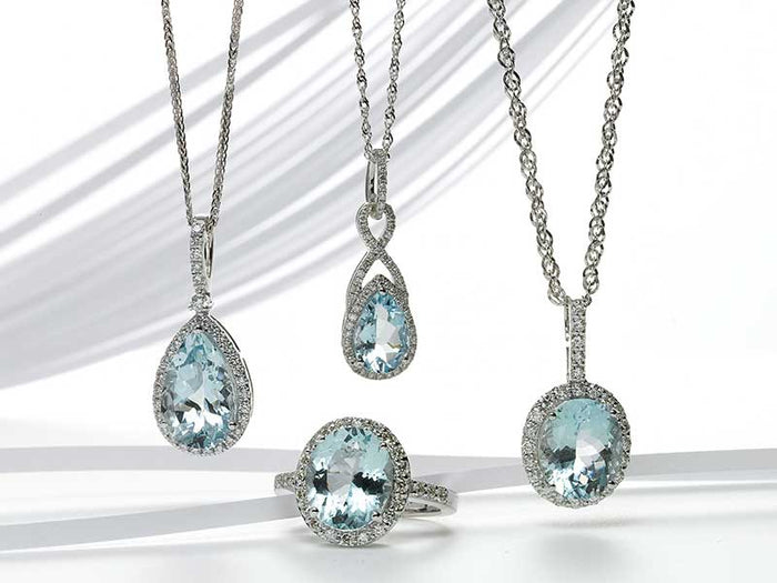 Aquamarine pendants and ring with diamond halos in white gold
