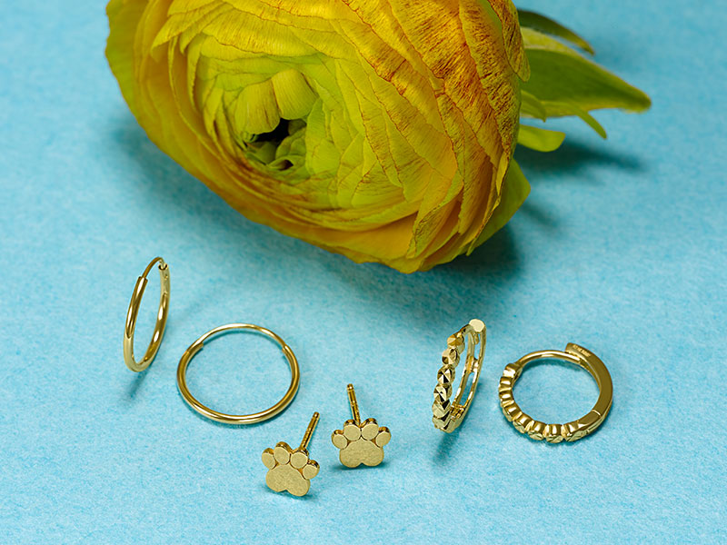 Gold hoop earrings and paw print stud earrings